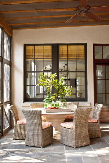 Kaufman Residence, decorated by Phoebe Howard, back porch-----
Screened back porch showing six wicker chairs around large round dining table.